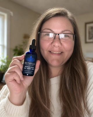Jessica holding a bottle of Methylia at home