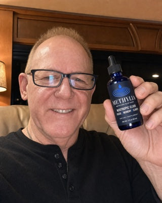 Robert holding a bottle of Methylia at home